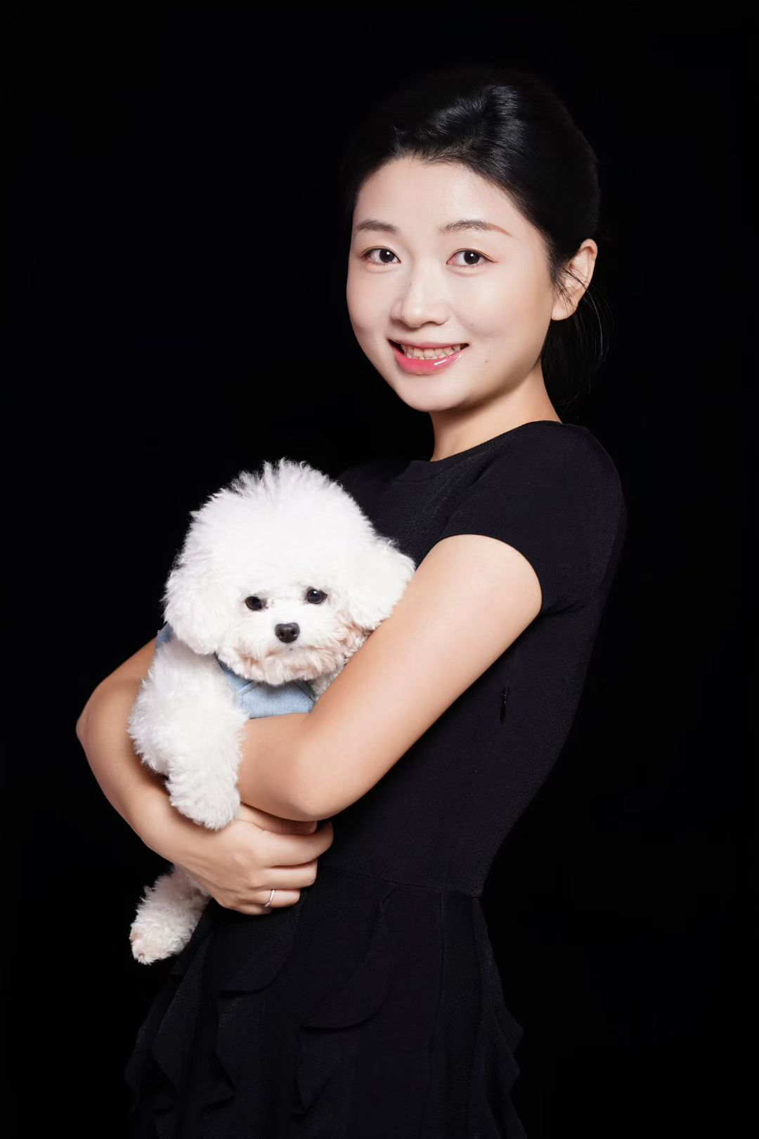 Jessica holding a white Bichon